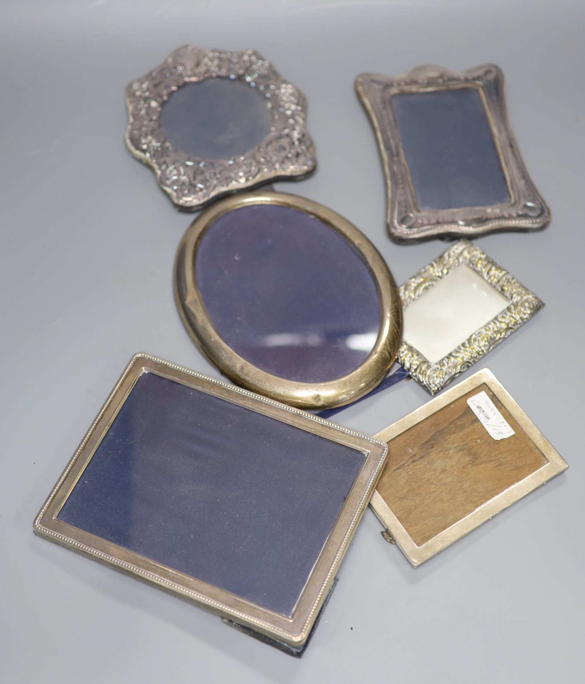 Four assorted silver mounted photograph frames, largest 21cm, one other white metal frame and a brass frame.